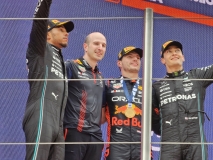 From left, P2 Lewis Hamilton, P1 Max Verstappen and P3 George Russel. Between Hamilton and Verstappen is a Red Bull engineer  accepting the winning constructor's trophy.