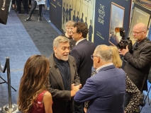 George Clooney (left) speaking with Governer Jay Inslee. At center is produced Grant Heslov